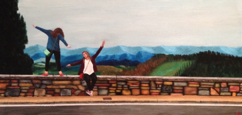 Painting of two young women on a stone wall in front of mountains.