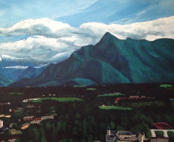 Painting of a large green mountain, blue sky, white clouds, and a valley filled with trees and some buildings.