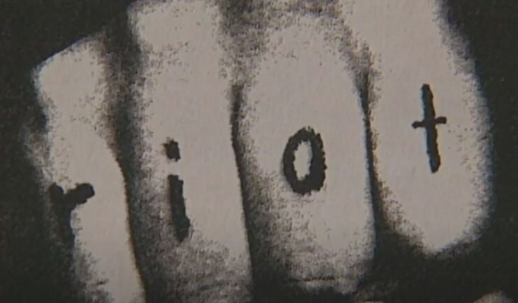 image of knuckles with 'riot'written on them - from MoPop's 2020 exhibit that featured riot grrrls