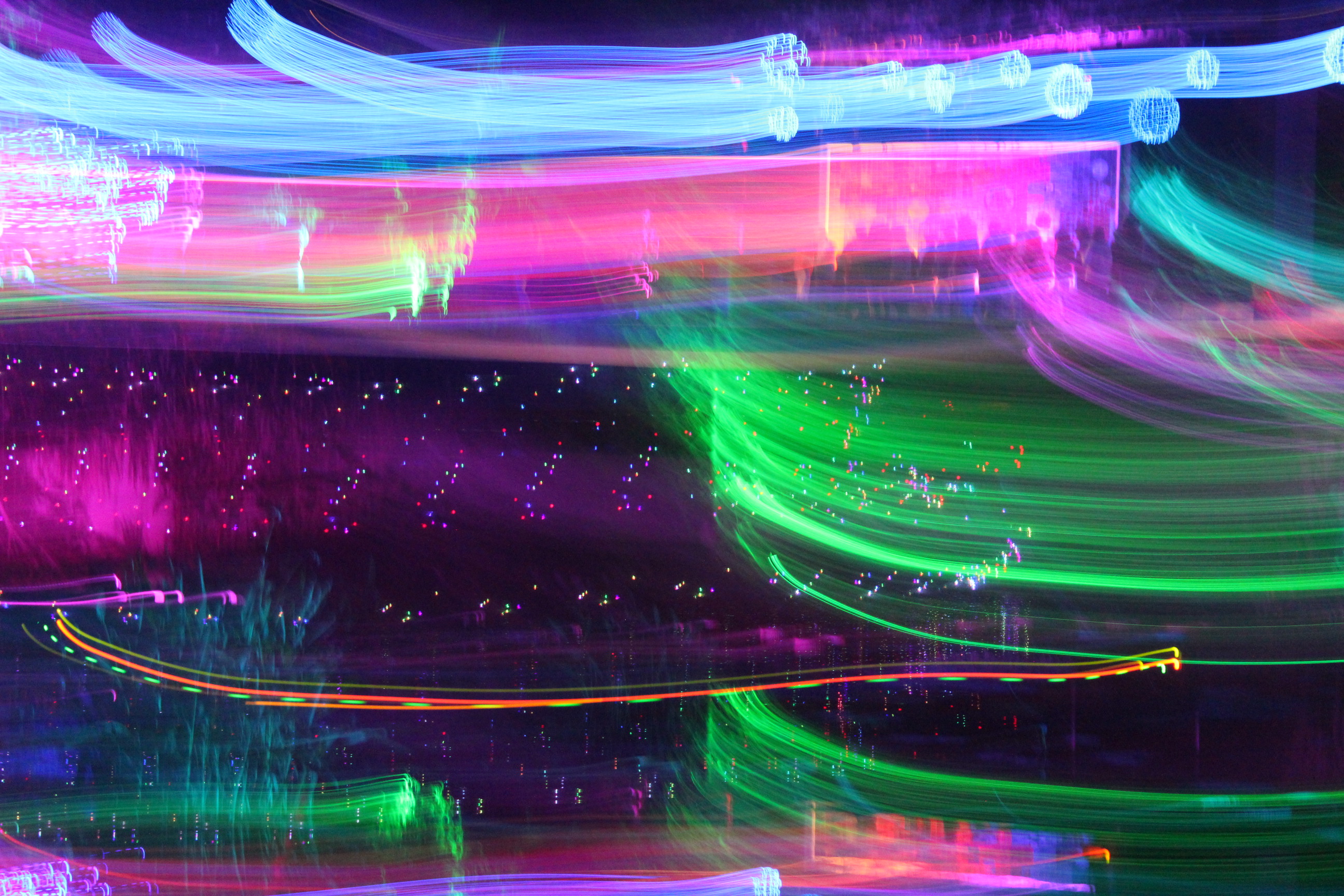 colorful lights smudged across image in slightly curved horizontal line