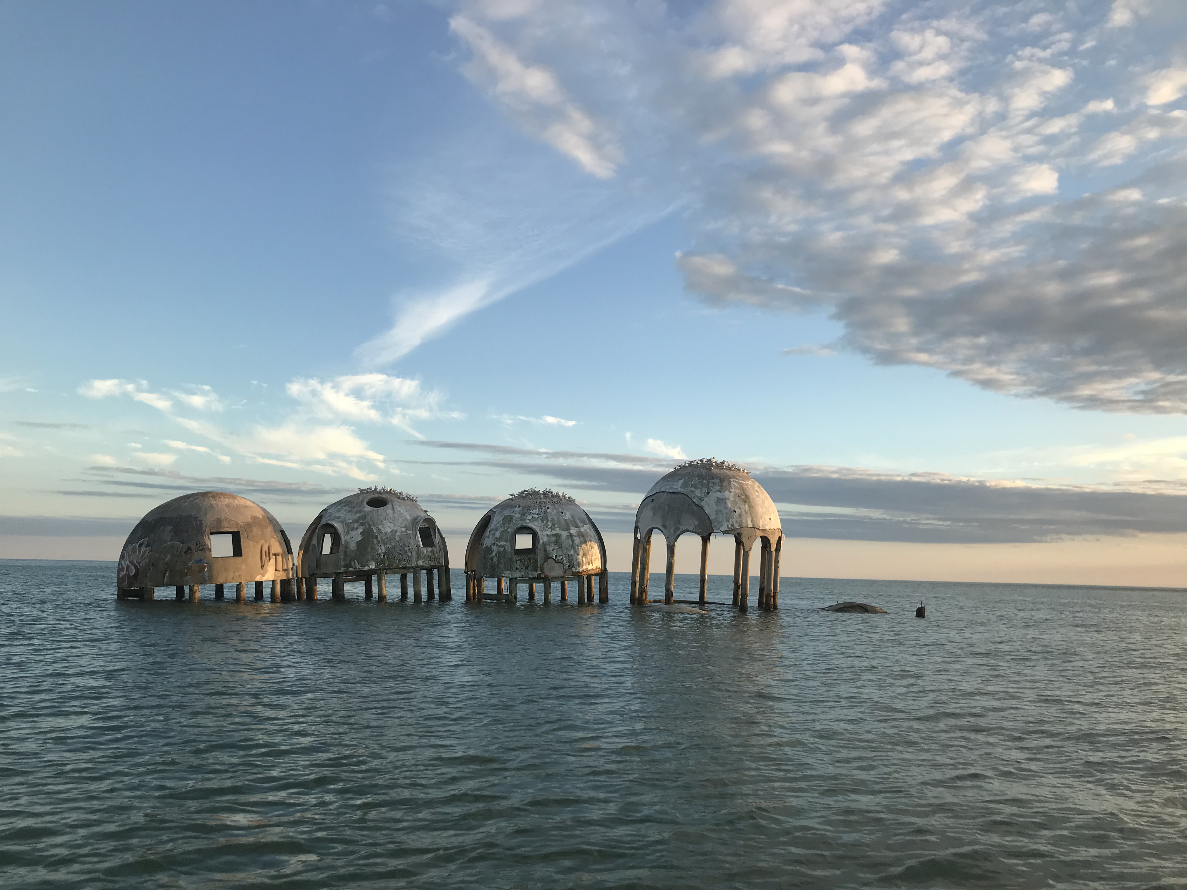 the top of an almost entirely submerged home peaking out above the water